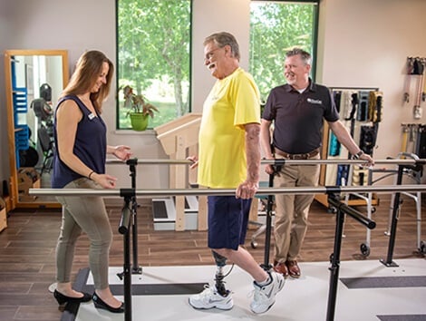 patient with prosthetic leg being treated by orthotists